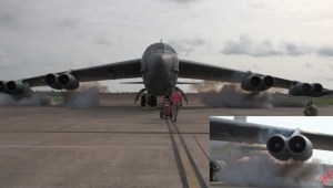 Air Force airmen jump start a B-52 bomber with explosive charges