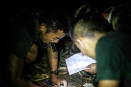 Saw Htoo Htoo and the rest of the team map out a land navigation point on their map.